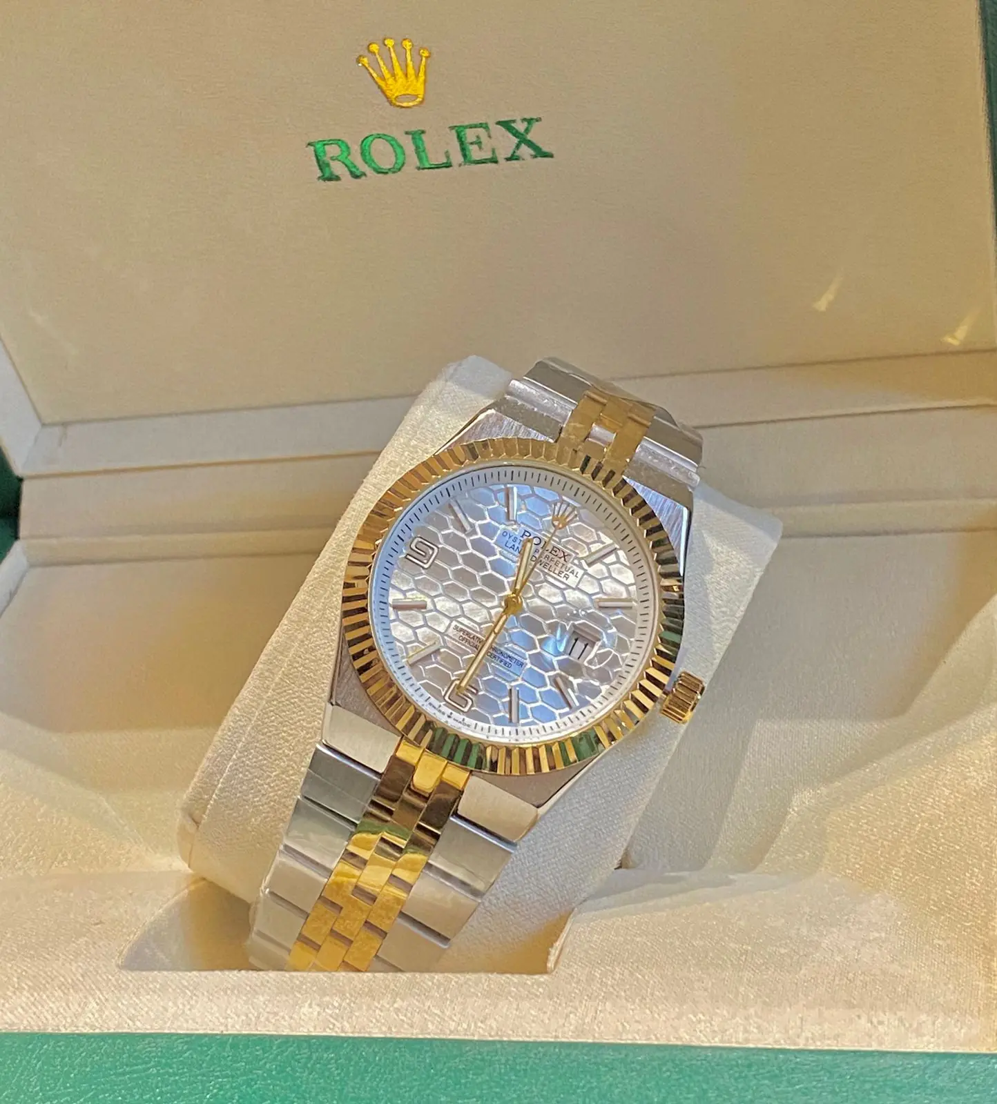 Rolex Oyster Perpetual Land-Dweller watch in Rolesor (steel and yellow gold) with a white honeycomb dial and fluted bezel_1.webp