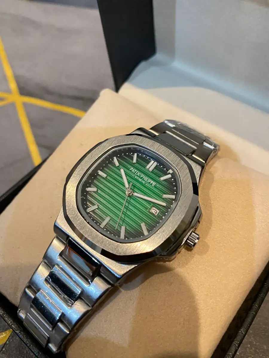 Patek Philippe Nautilus watch with a green dial and stainless steel case and bracelet.webp