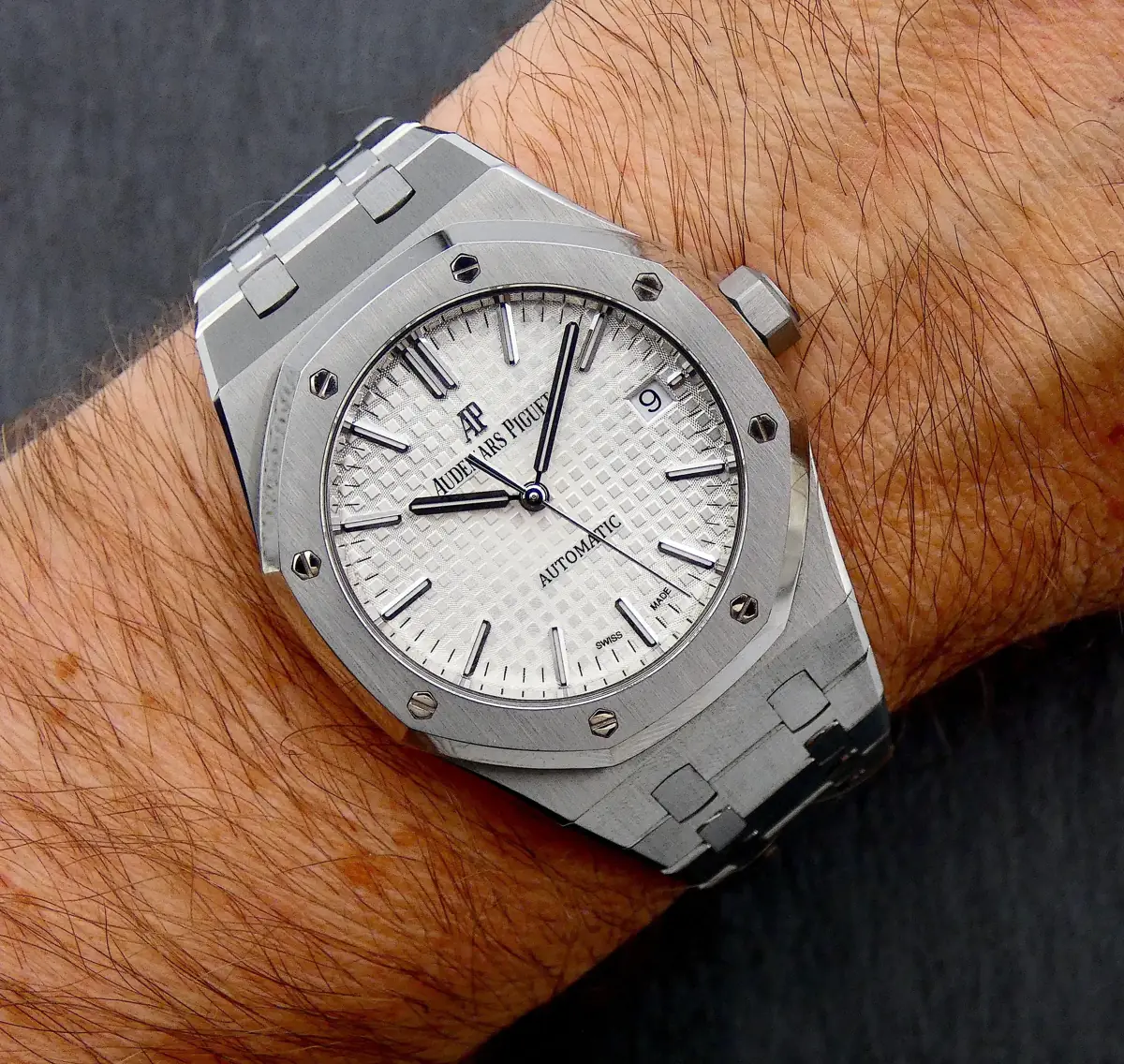 Audemars Piguet Royal Oak silver-toned watch with a white or silver dial and an integrated steel bracelet (1).webp