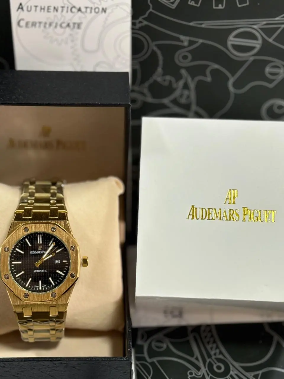 Audemars Piguet Royal Oak watch in a yellow gold-tone finish with a black Grande Tapisserie dial_2.webp