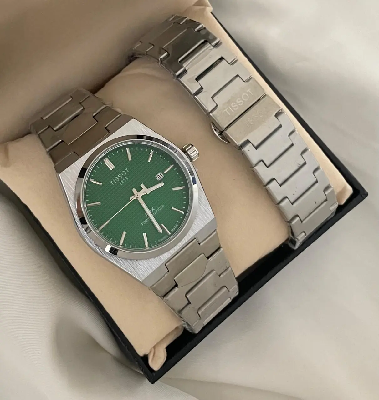 Tissot PRX powermatic watch with a green dial and stainless steel integrated bracelet