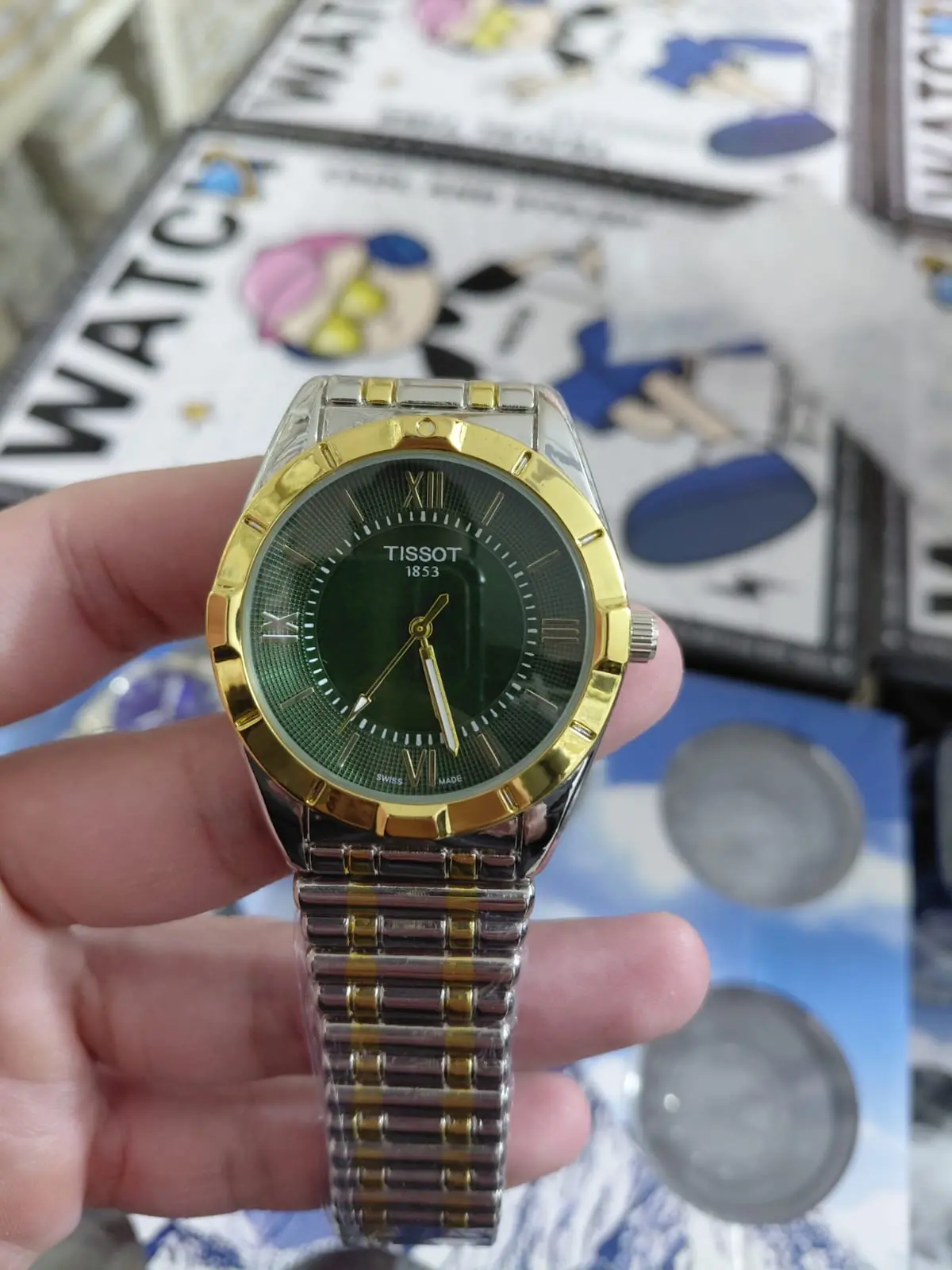 Tissot watch with a green dial and a two-tone gold bracelet